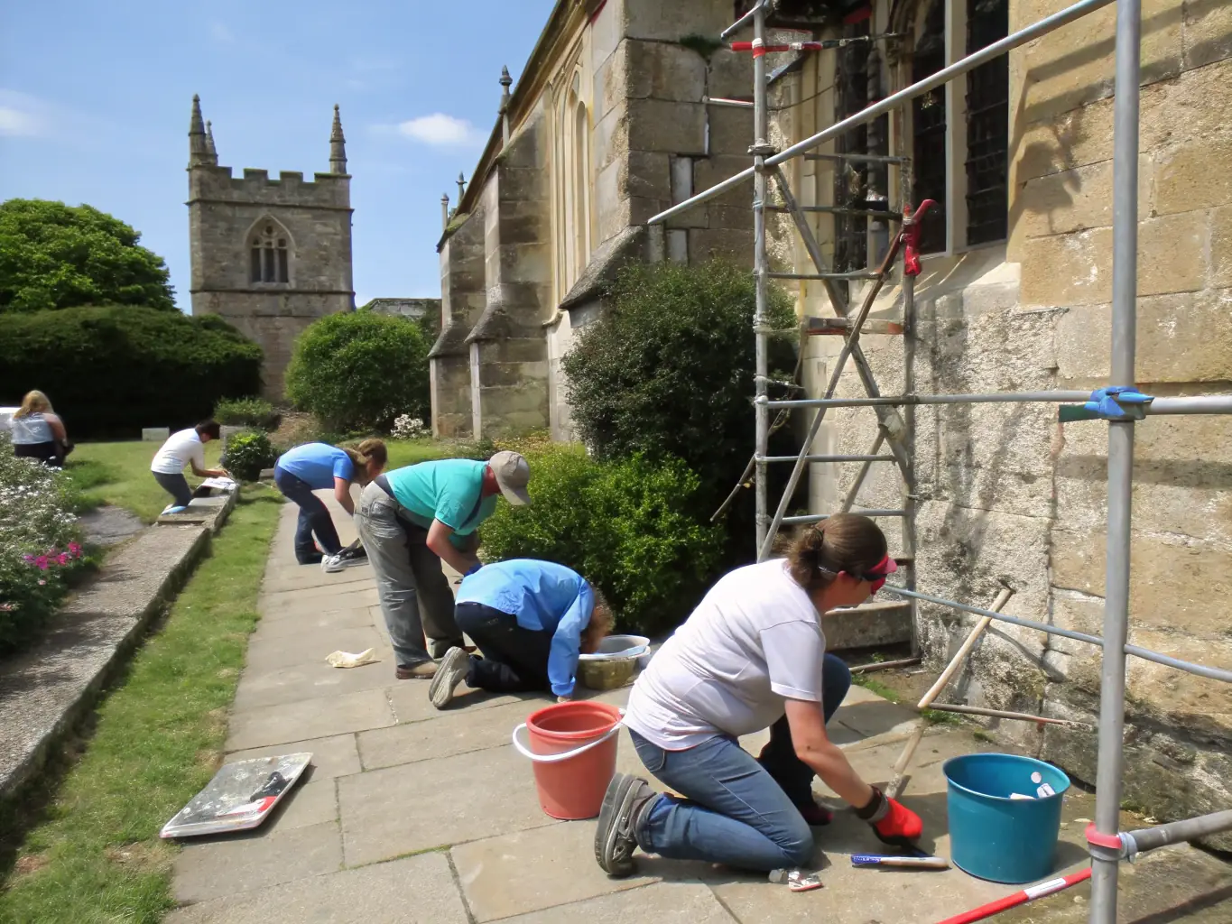 A captivating image of community members participating in a cultural heritage preservation project, working together to restore a historic building or artifact.